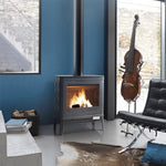 Modern living room with a lit wood stove, black chair, and violin in the background.